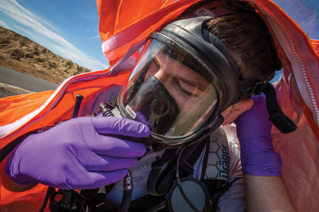 Senior Airman Alex J. Potts, a member of the New Jersey Guard’s 21st Weapons of of Mass Destruction-Civil Support Team, dons a self-contained breathing apparatus during a recent exercise.