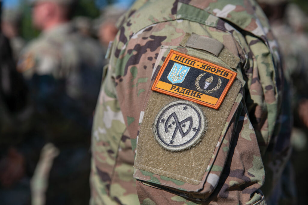 A Task Force Orion soldier wears the Combat Training Center-Yavoriv patch above his brigade patch during the transfer of authority ceremony.