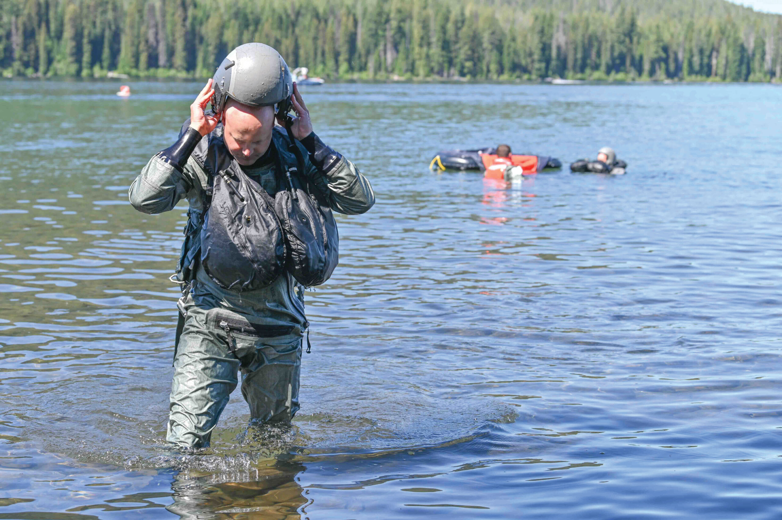 Col. Lee Bouma, the commander of the 173rd Fighter Wing, doffs his helmet following his circuit through several water survival training scenarios at Cultus Lake in central Oregon.