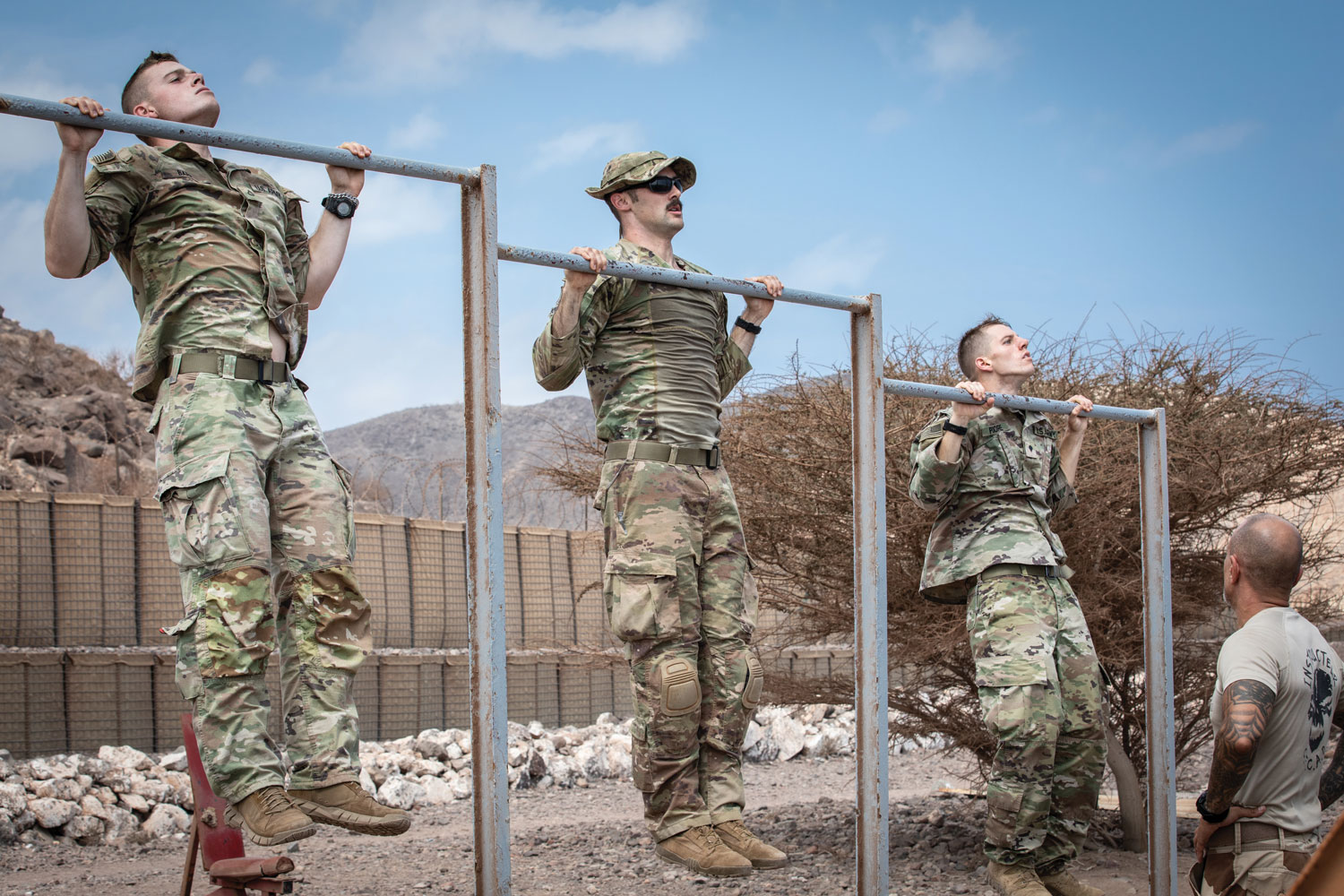 Guard soldiers with Task Force Red Dragon do pull-ups as part of the French Desert Commando Course.