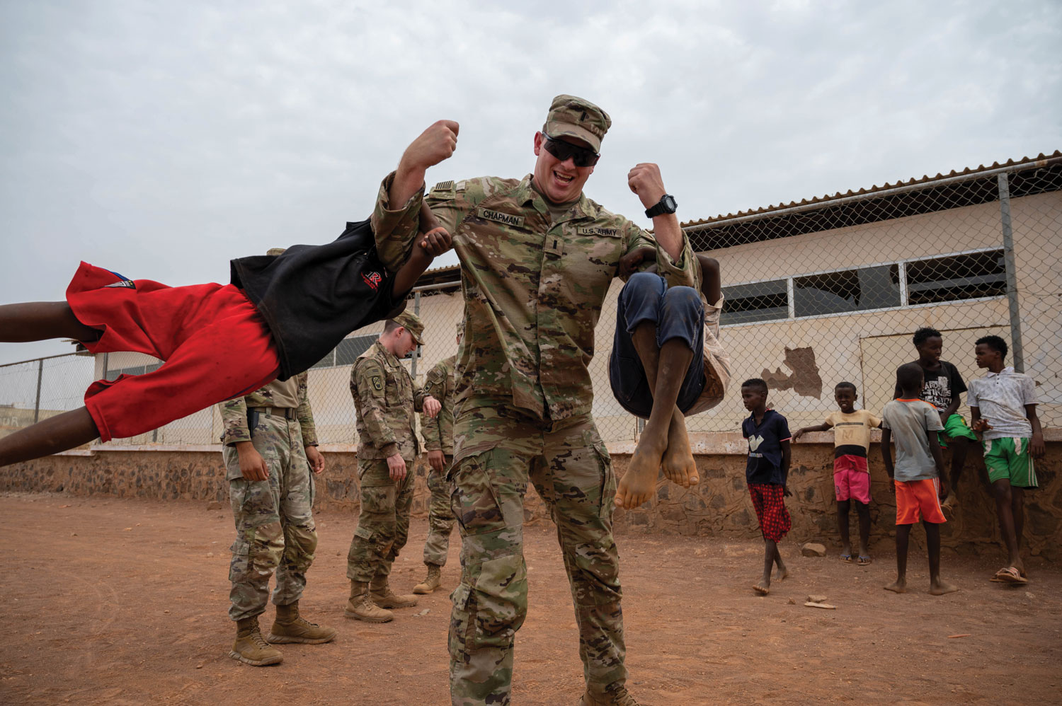 First Lt. Austin Chapman, a member of the Tennessee Army Guard’s 268th Military Police Company, plays with children during a visit to Chabelley village, Djibouti.