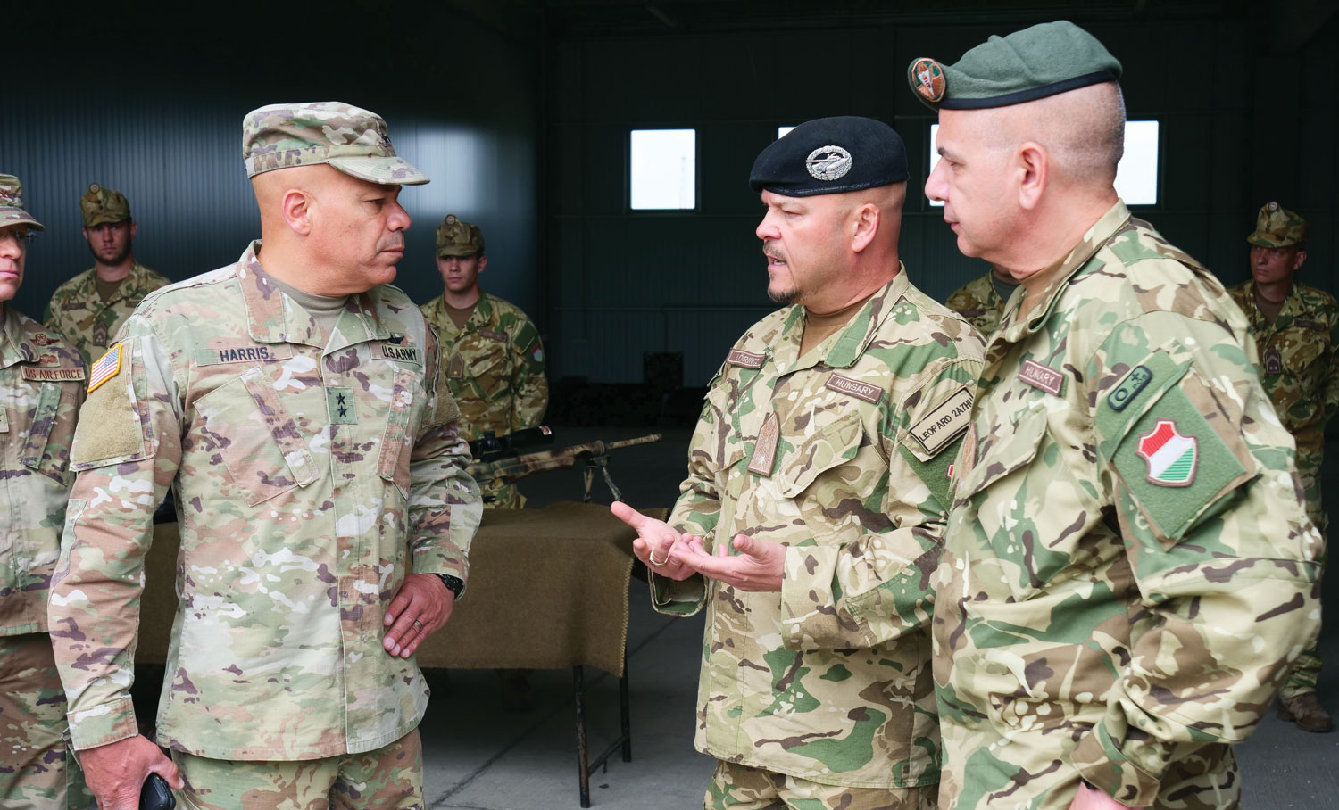 Maj. Gen. John C. Harris Jr., the adjutant general of Ohio, discusses weapons systems with Hungarian officers during his visit to Hungary as part of the Guard State Partnership Program.